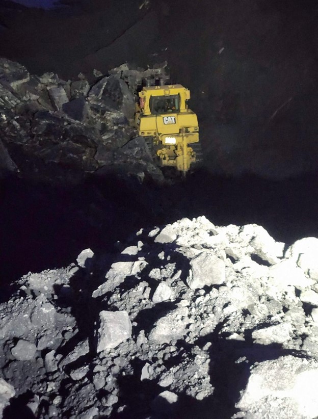 A photo of the dozer partially buried at CST's Grand Cache coal mine following a wall instability and collapse (c/o United Mine Workers/The Canadian Press).